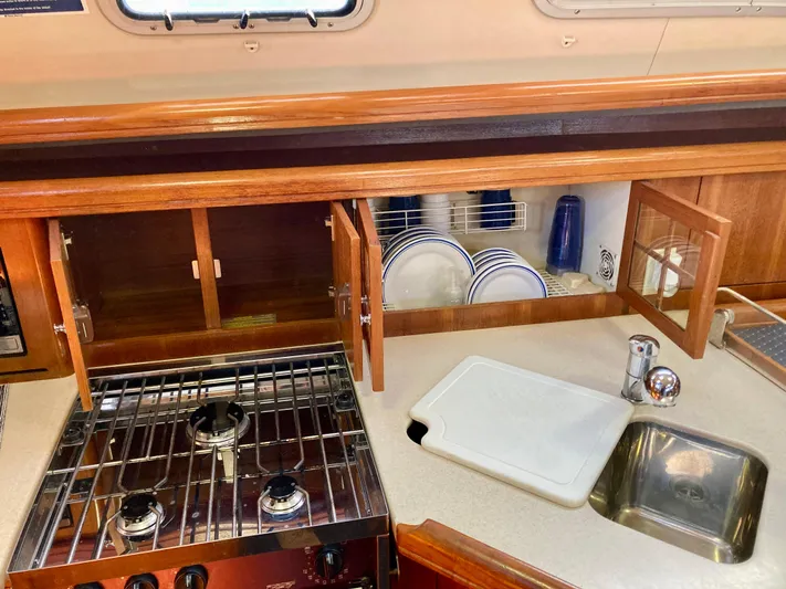 Light Seeker Yacht Photos Pics Galley kitchen in 2005 Hunter 41 AC sailboat with stove, sink, and dish storage.