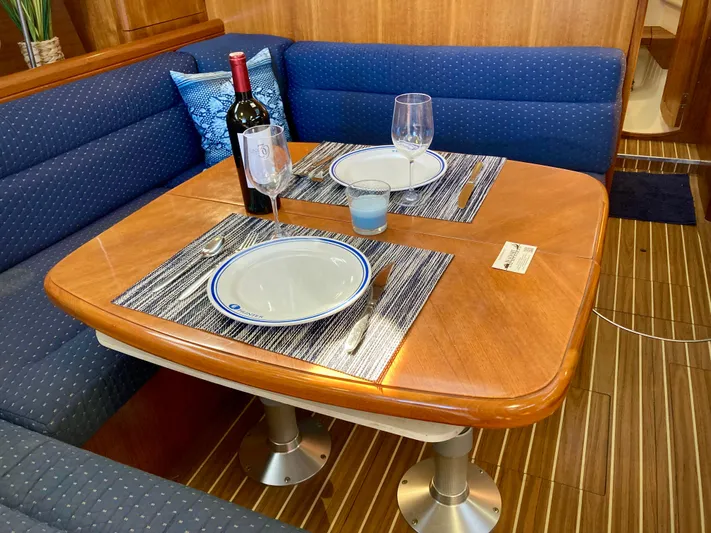 Light Seeker Yacht Photos Pics Elegant dining setup in 2005 Hunter 41 AC yacht interior with wine and tableware.