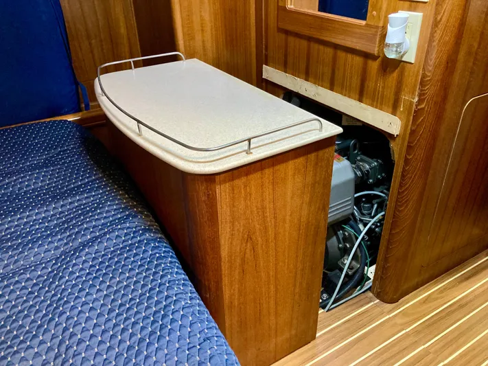 Light Seeker Yacht Photos Pics Interior of 2005 Hunter 41 AC sailboat showing engine access and wooden cabinetry.