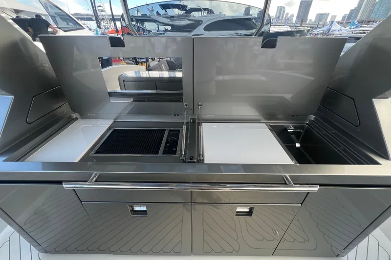  Yacht Photos Pics Outdoor kitchen on 2023 Canados 493 Gladiator yacht, featuring grill and sink.