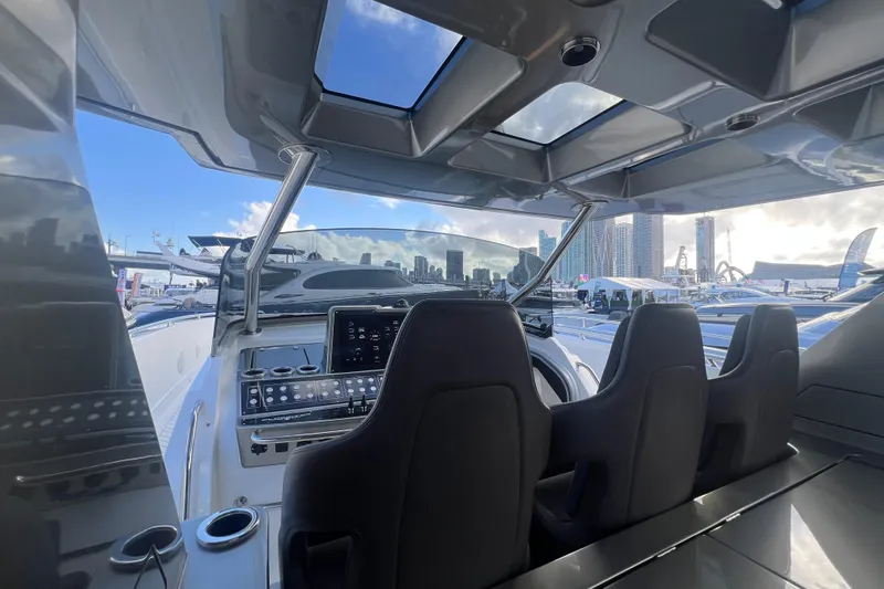  Yacht Photos Pics Interior view of 2023 Canados 493 Gladiator yacht cockpit with modern controls and city skyline.