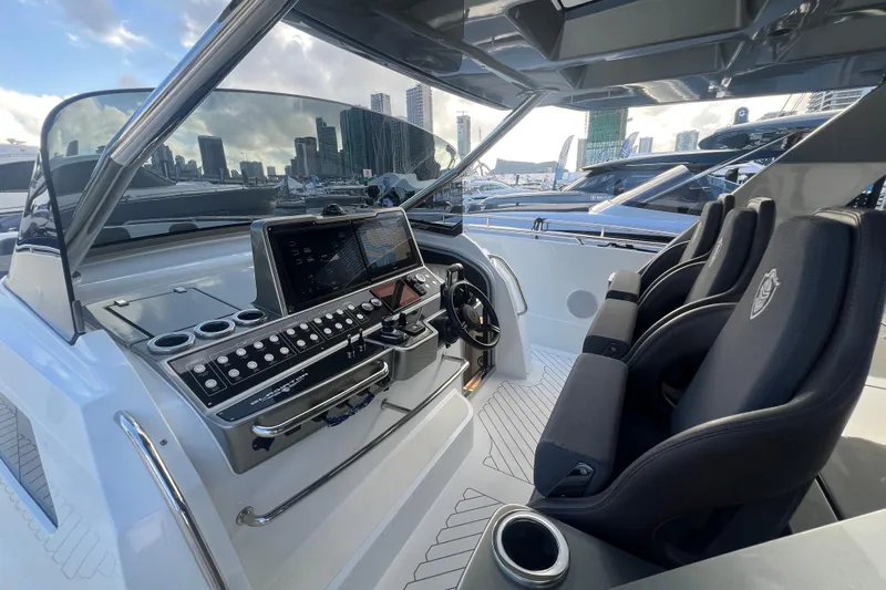  Yacht Photos Pics 2023 Canados 493 Gladiator yacht cockpit with modern controls and luxurious seating.