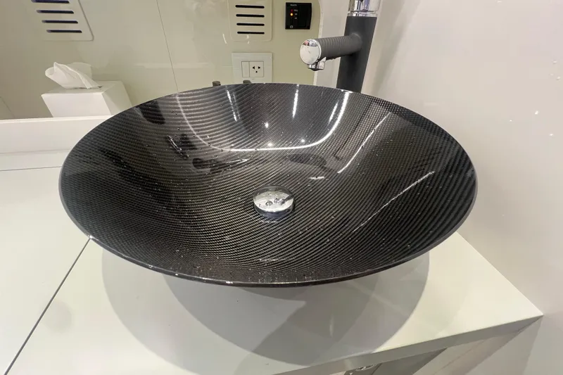  Yacht Photos Pics Carbon fiber sink in a modern bathroom on the 2023 Canados 493 Gladiator yacht.