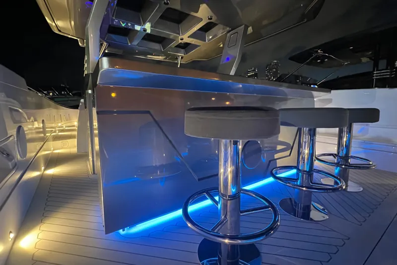  Yacht Photos Pics Luxurious 2023 Canados 493 Gladiator yacht bar area with modern seating and ambient lighting.