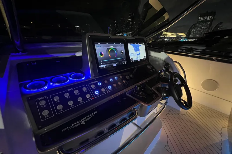  Yacht Photos Pics 2023 Canados 493 Gladiator yacht cockpit with illuminated controls and navigation screens at night.