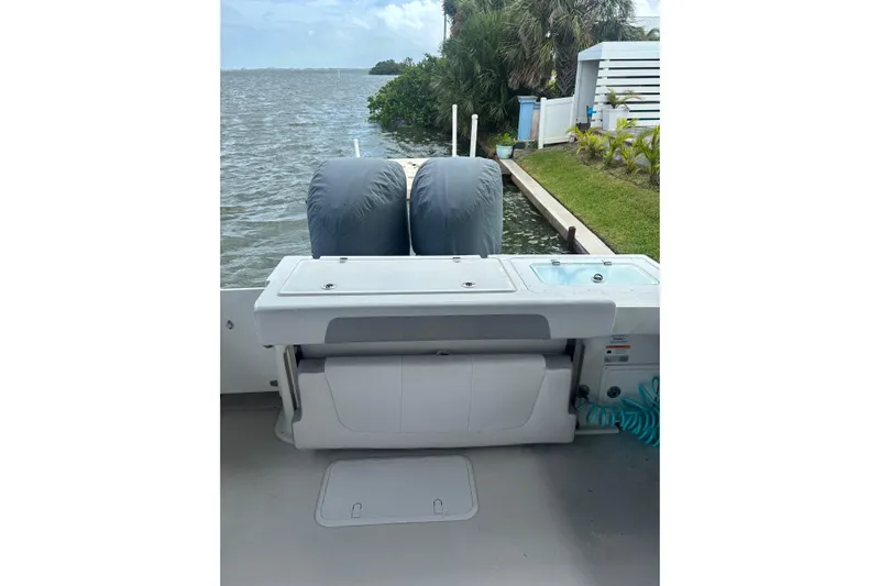  Yacht Photos Pics 2024 Parker 2820 XLD Sport Cabin boat with covered engines by the water.