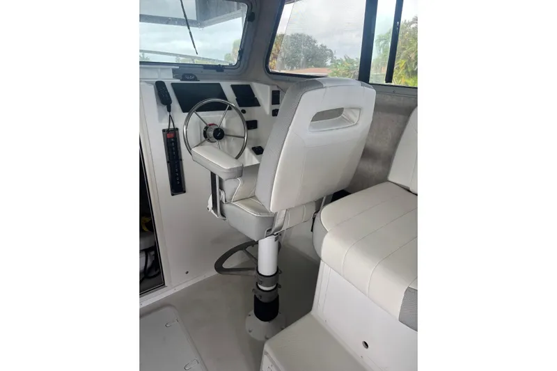  Yacht Photos Pics 2024 Parker 2820 XLD Sport Cabin interior with steering wheel and seating.
