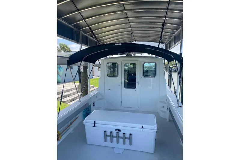  Yacht Photos Pics 2024 Parker 2820 XLD Sport Cabin boat interior with canopy and storage box.