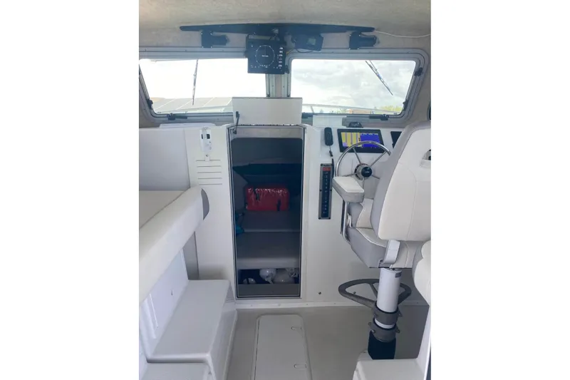  Yacht Photos Pics 2024 Parker 2820 XLD Sport Cabin interior with helm, seating, and navigation equipment.