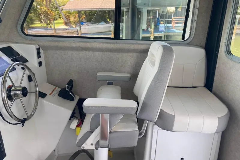  Yacht Photos Pics 2024 Parker 2820 XLD Sport Cabin interior with steering wheel and seating.