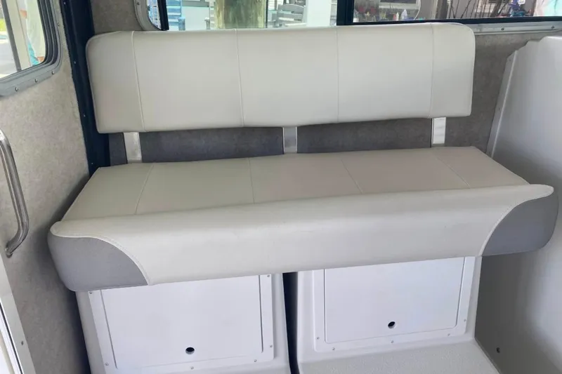  Yacht Photos Pics 2024 Parker 2820 XLD Sport Cabin interior seating with storage compartments.