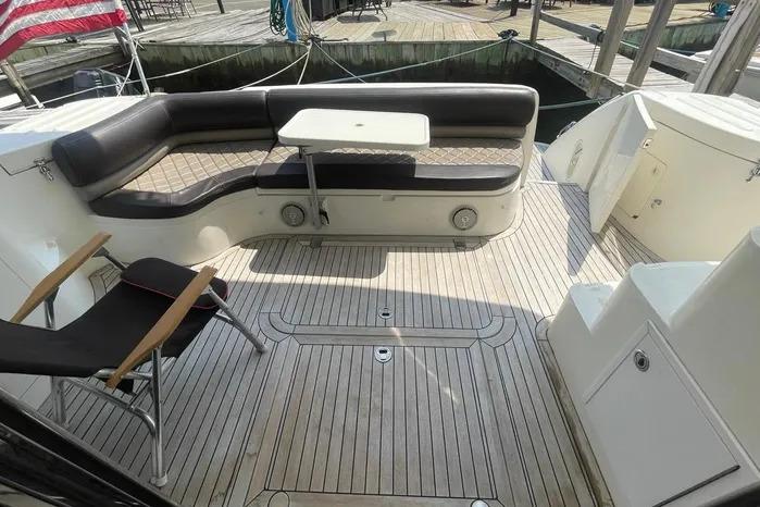 2001 Viking Princess yacht deck with seating and table, ready for sale.