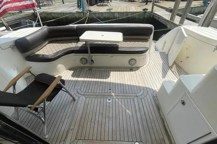 2001 Viking Princess yacht deck with seating and table, ready for sale.