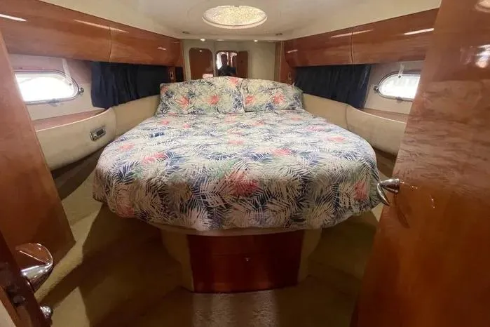  Yacht Photos Pics Luxurious 2001 Viking Princess yacht bedroom with floral bedding and elegant wood finishes.
