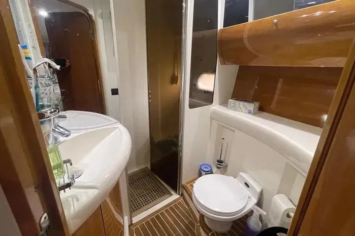  Yacht Photos Pics Luxurious 2001 Viking Princess yacht bathroom with modern amenities and elegant wood finishes.