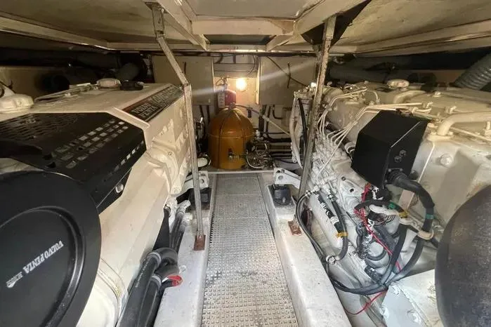  Yacht Photos Pics Engine room of 2001 Viking Princess yacht, showcasing dual engines and mechanical components.