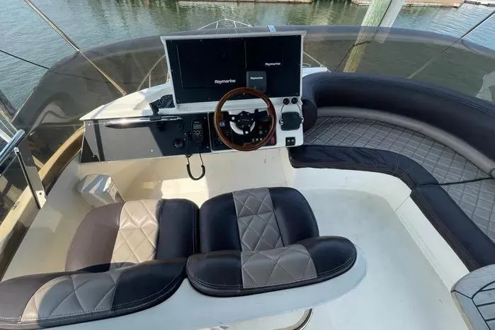  Yacht Photos Pics 2001 Viking Princess boat helm with dual screens and luxury seating.
