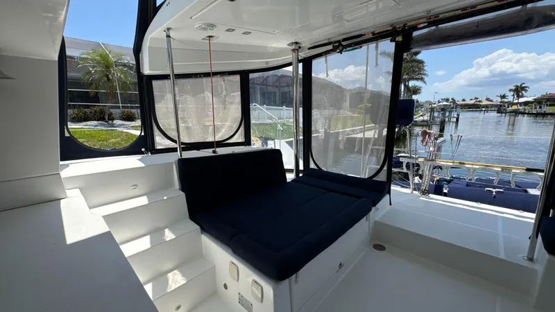 Aquamarine Yacht Photos Pics 2013 Lagoon 450 F yacht interior with seating, steps, and marina view.