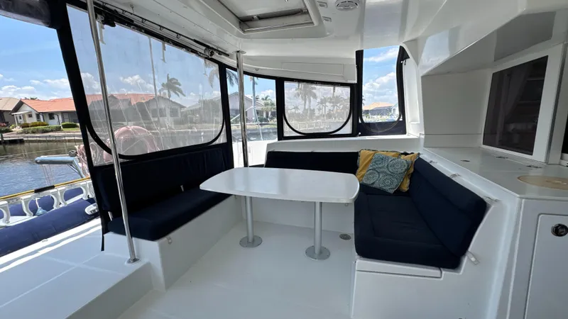 Aquamarine Yacht Photos Pics Interior of 2013 Lagoon 450 F catamaran with seating area and table, dockside view.