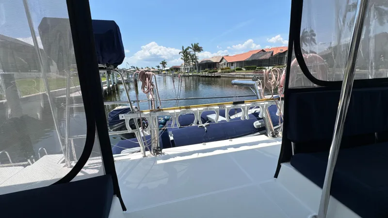Aquamarine Yacht Photos Pics View from Lagoon 450 F catamaran, docked by a scenic waterfront with palm trees.