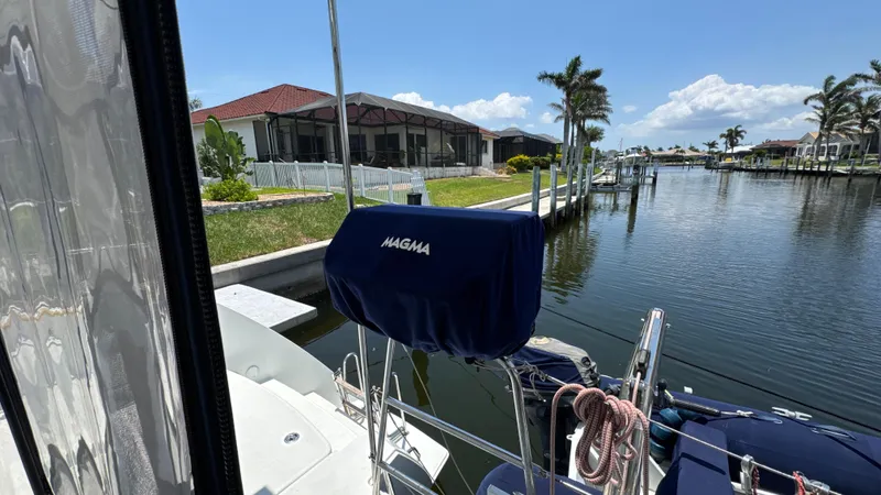 Aquamarine Yacht Photos Pics Lagoon 450 F yacht docked by a scenic waterfront with palm trees, 2013 model.