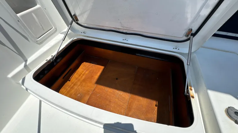 Aquamarine Yacht Photos Pics Open storage compartment on 2013 Lagoon 450 F yacht, featuring wooden interior.