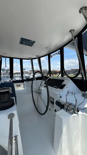 Aquamarine Yacht Photos Pics Interior view of 2013 Lagoon 450 F catamaran cockpit with steering wheel and controls.