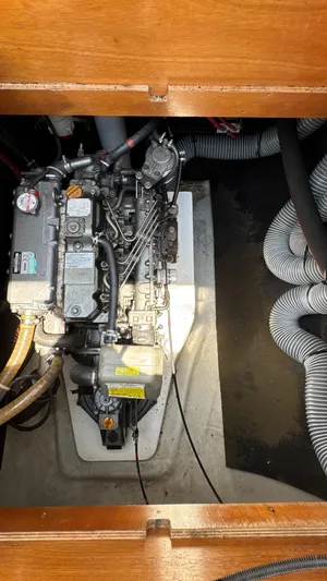 Aquamarine Yacht Photos Pics Engine compartment of a 2013 Lagoon 450 F catamaran, showcasing mechanical components and hoses.