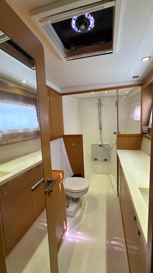 Aquamarine Yacht Photos Pics Interior of 2013 Lagoon 450 F yacht bathroom with modern fixtures and wood accents.