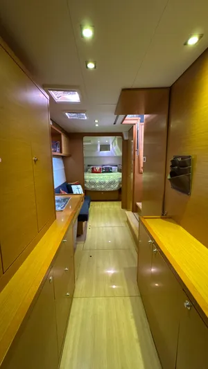 Aquamarine Yacht Photos Pics Interior of 2013 Lagoon 450 F yacht, featuring wood cabinetry and cozy sleeping area.