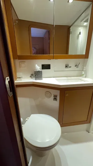 Aquamarine Yacht Photos Pics Bathroom interior of 2013 Lagoon 450 F yacht, featuring modern fixtures and wooden cabinetry.