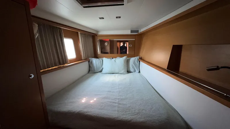 Aquamarine Yacht Photos Pics Cozy cabin interior of 2013 Lagoon 450 F catamaran with bed and windows.