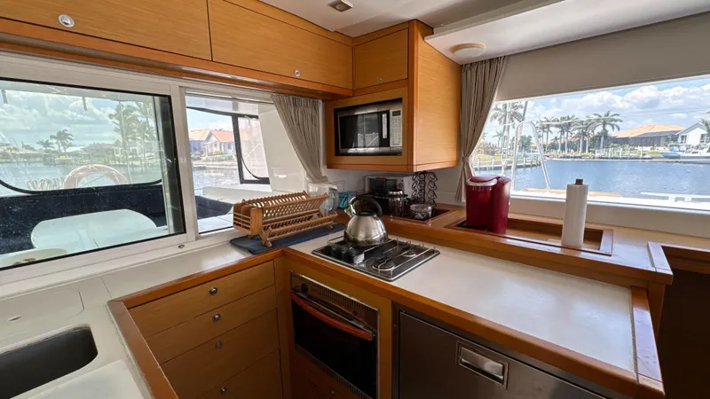 Aquamarine Yacht Photos Pics Modern kitchen interior of 2013 Lagoon 450 F yacht with appliances and waterfront view.