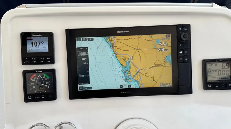 Aquamarine Yacht Photos Pics Navigation system on a 2013 Lagoon 450 F catamaran, displaying nautical charts and instruments.