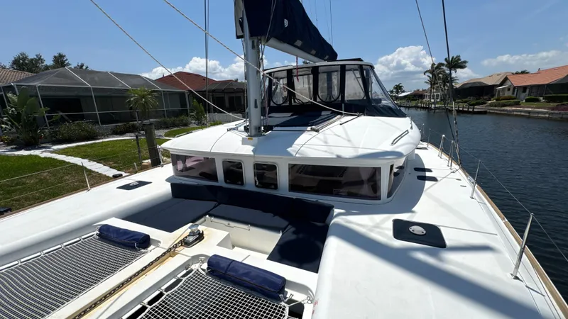 Aquamarine Yacht Photos Pics 2013 Lagoon 450 F catamaran docked in a sunny canal setting.