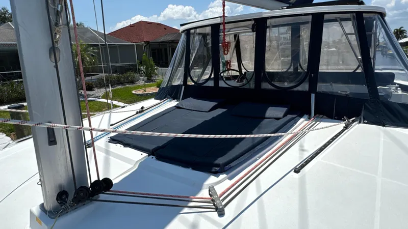 Aquamarine Yacht Photos Pics 2013 Lagoon 450 F catamaran deck with sunshade and rigging, docked near residential area.