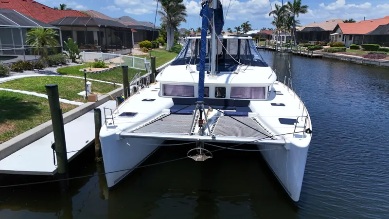 Aquamarine Yacht Photos Pics 2013 Lagoon 450 F catamaran docked in a scenic canal setting.