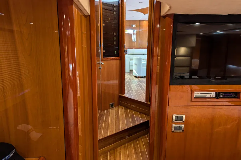  Yacht Photos Pics Luxurious interior of 2006 Sunseeker Predator 68 yacht with wood paneling and modern amenities.