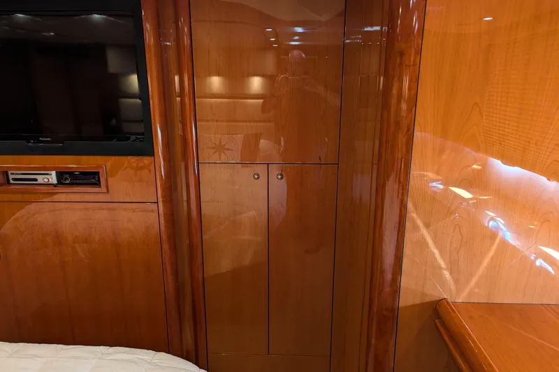  Yacht Photos Pics Luxurious wooden interior of 2006 Sunseeker Predator 68 yacht with TV and cabinetry.