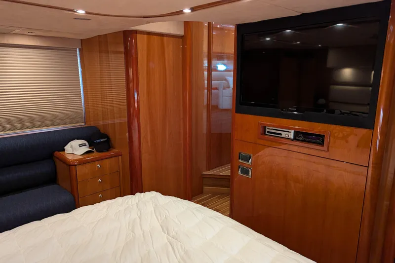  Yacht Photos Pics Luxurious interior of 2006 Sunseeker Predator 68 yacht with TV and wood paneling.