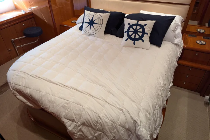  Yacht Photos Pics Luxurious cabin interior of 2006 Sunseeker Predator 68 yacht with nautical-themed bedding.