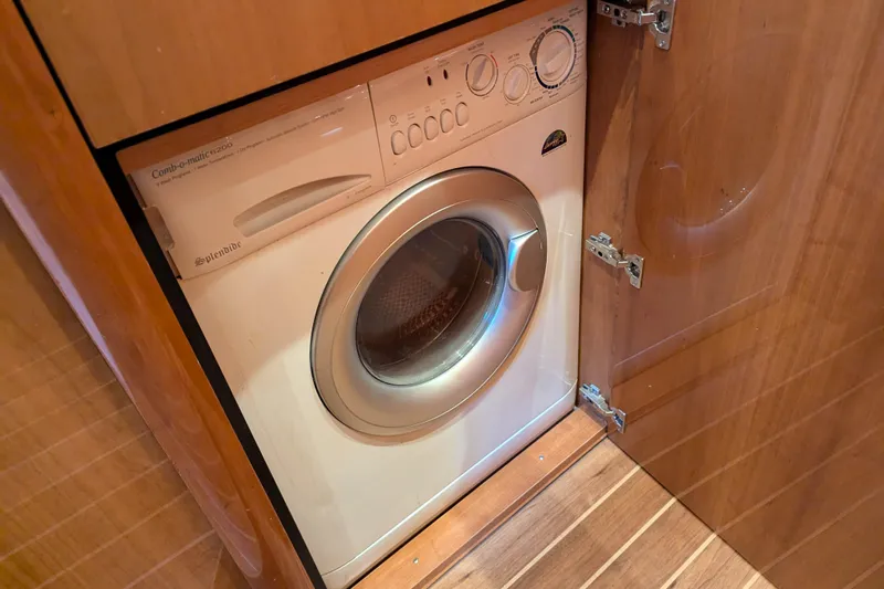  Yacht Photos Pics Washing machine inside 2006 Sunseeker Predator 68 yacht, wooden cabinetry.