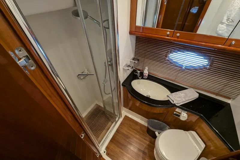 Yacht Photos Pics Luxurious bathroom in 2006 Sunseeker Predator 68 yacht with shower, sink, and toilet.