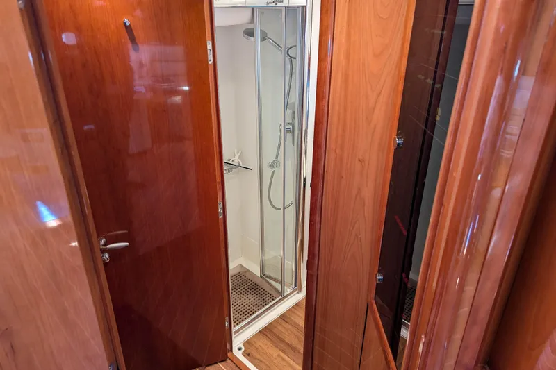 Yacht Photos Pics Luxurious wooden interior of 2006 Sunseeker Predator 68 yacht bathroom with shower.