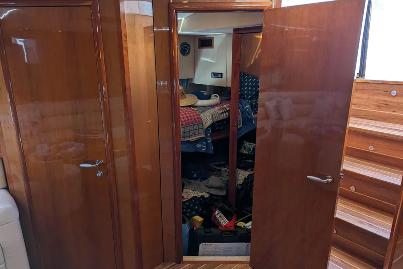  Yacht Photos Pics Interior of 2006 Sunseeker Predator 68 yacht with open wooden doors and visible storage.