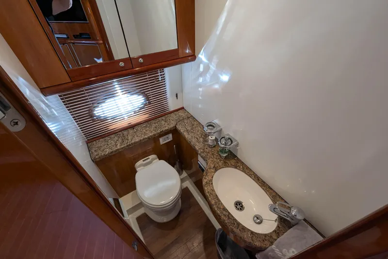  Yacht Photos Pics Luxurious bathroom in 2006 Sunseeker Predator 68 yacht with granite countertop and wooden accents.