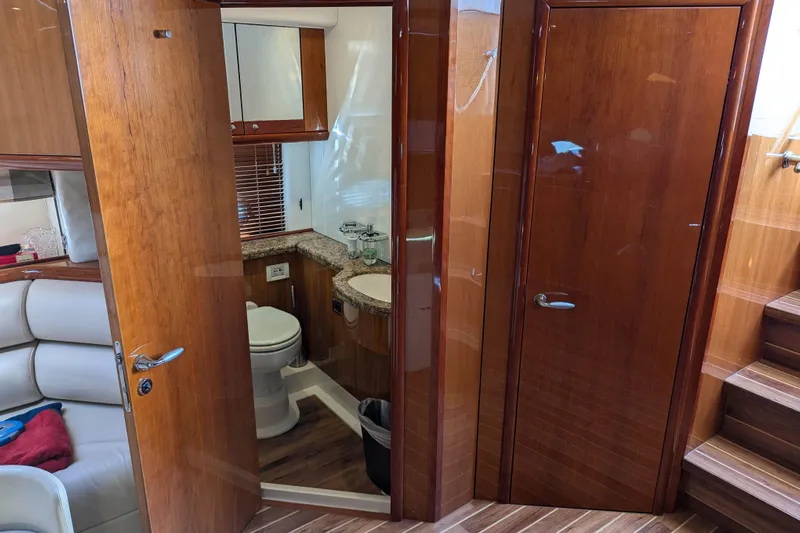 Yacht Photos Pics Luxurious 2006 Sunseeker Predator 68 yacht interior with wooden finishes and modern bathroom.