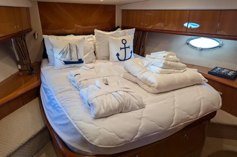  Yacht Photos Pics Luxurious cabin interior of 2006 Sunseeker Predator 68 yacht with nautical-themed bedding.