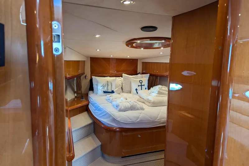  Yacht Photos Pics Luxurious cabin interior of 2006 Sunseeker Predator 68 yacht with elegant wood finish.