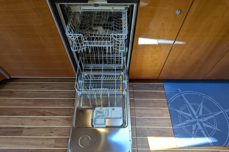  Yacht Photos Pics Open dishwasher in Sunseeker Predator 68 yacht, 2006 model, with wooden flooring.